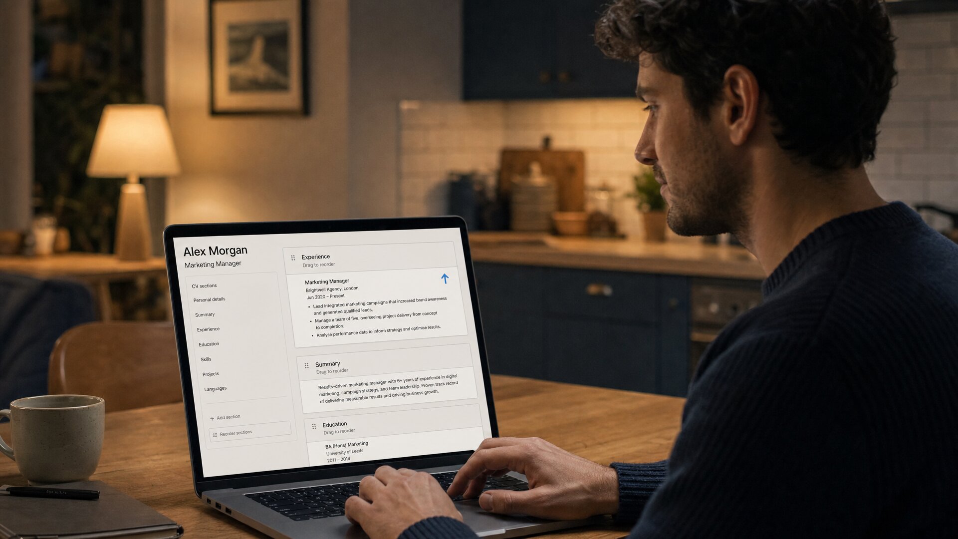 A man at a kitchen table dragging the Experience block above Summary in his CV editor.